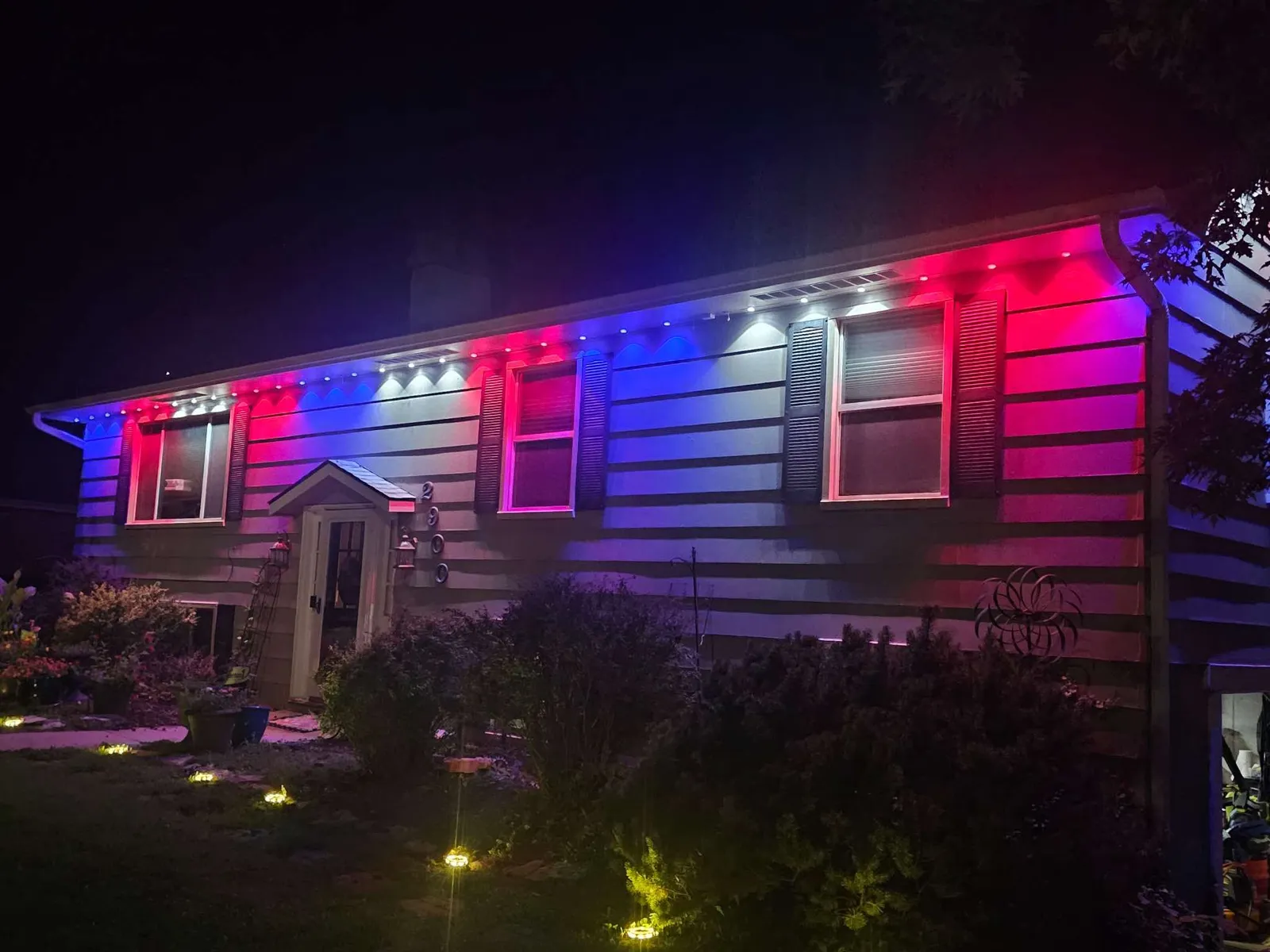 Permanent smart lighting showing red, white and blue on a San Antonio home